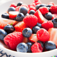 A bowl of mixed keto fruit salad, including strawberries, blueberries, and sliced melon, vividly colorful and close-up.