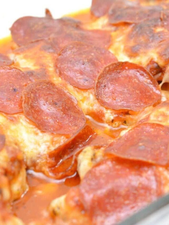 Close-up of a chicken pizza casserole with melted cheese and pepperoni slices, featuring a golden-brown, slightly oily surface, reminiscent of classic pizza or lasagna.